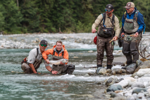 Group of guides and anglers admiring a nice bull trout
