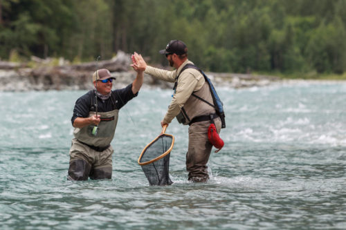 Angler and guide giving a high five after landing a nice fish