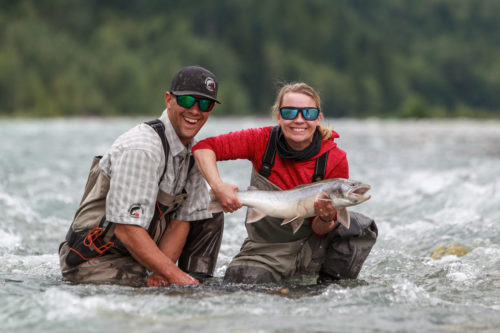Two anglers holding a large bull trout on the Pitt River